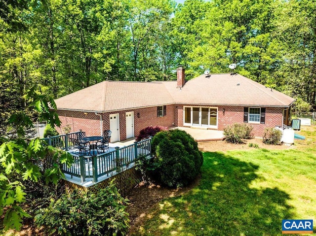 18220 Gregory Dr, Gordonsville, VA 22942 - rear view of house featuring a yard, a shingled roof, a chimney, and brick siding