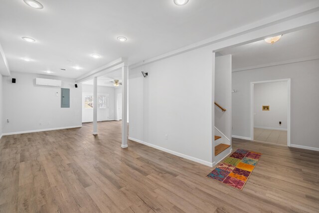 basement featuring electric panel, stairs, wood finished floors, baseboards, and recessed lighting