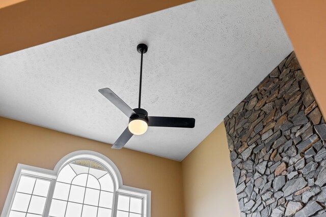 room details featuring a ceiling fan and a textured ceiling