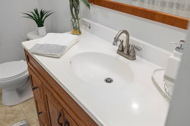bathroom with vanity, tile patterned floors, and toilet