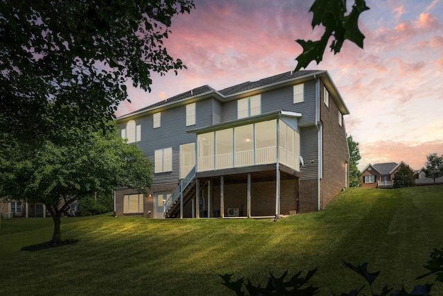 15 Brookmere Ct, Staunton, VA 24401 - back of property at dusk with a sunroom, a yard, and stairway