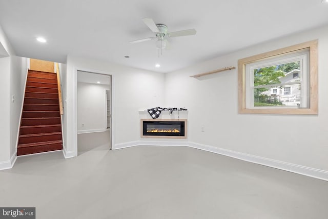  - unfurnished living room with recessed lighting, stairway, ceiling fan, and a glass covered fireplace