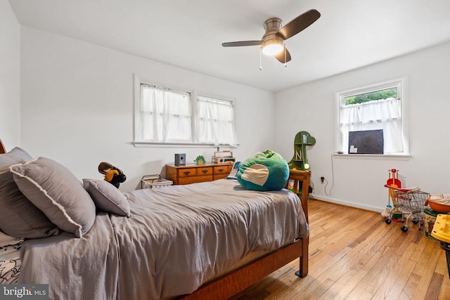  - bedroom featuring light wood-type flooring and ceiling fan