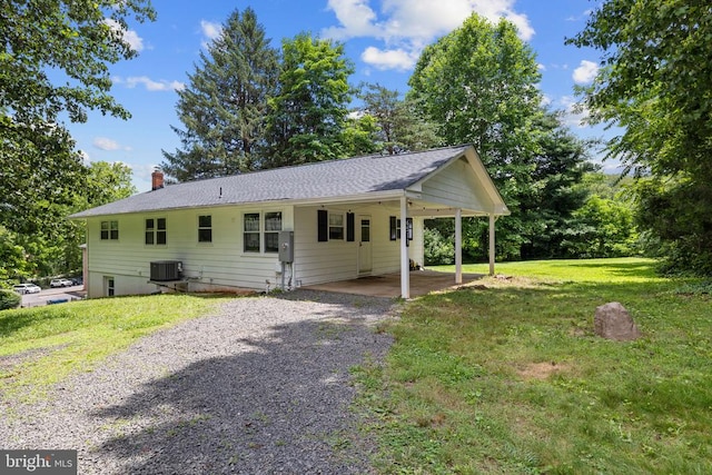  - ranch-style home featuring driveway, a front lawn, a chimney, a carport, and a shingled roof