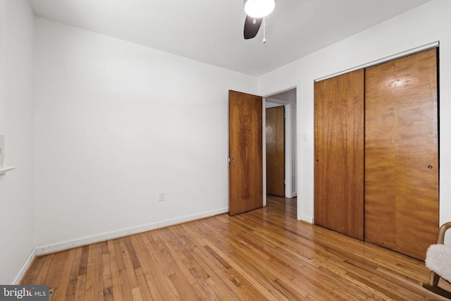  - unfurnished bedroom featuring light wood-type flooring, a closet, and ceiling fan