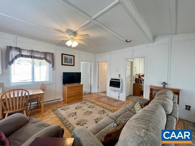 1308 Spruce St, Monterey, VA 24465 - living room with light wood-style flooring, heating unit, a baseboard heating unit, ceiling fan, and a decorative wall