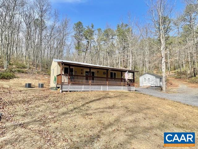 1308 Spruce St, Monterey, VA 24465 - view of front of house featuring a porch, a forest view, and an outbuilding