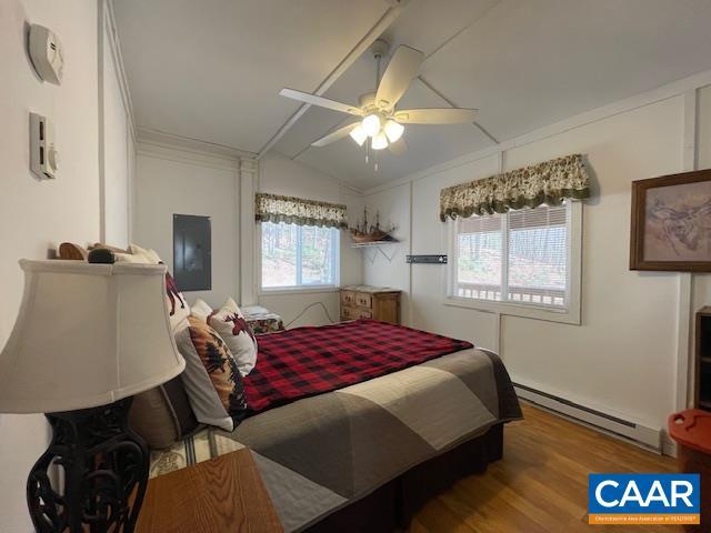 1308 Spruce St, Monterey, VA 24465 - bedroom with lofted ceiling, wood finished floors, crown molding, a ceiling fan, and baseboard heating