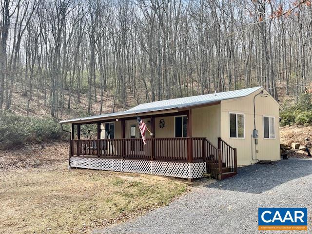 1308 Spruce St, Monterey, VA 24465 - manufactured / mobile home featuring metal roof, a porch, and a wooded view