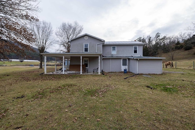 15745 Runions Creek Rd, Broadway, VA 22815 - rear view of property featuring metal roof, a patio area, and a lawn