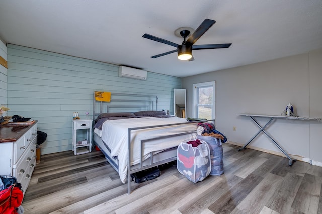15745 Runions Creek Rd, Broadway, VA 22815 - bedroom featuring wooden walls, wood finished floors, a ceiling fan, and an AC wall unit