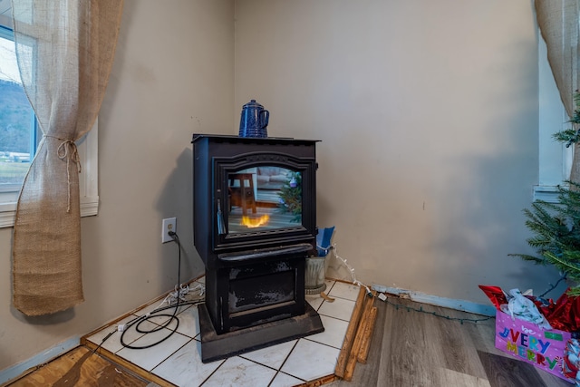 15745 Runions Creek Rd, Broadway, VA 22815 - room details featuring a wood stove, wood finished floors, and baseboards