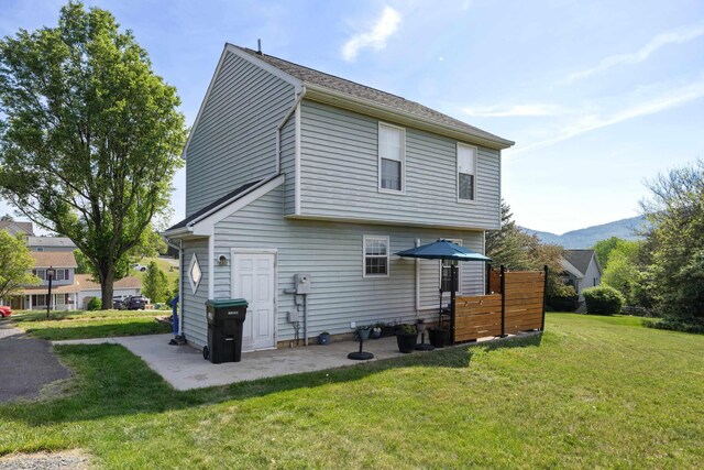 back of property featuring a yard and a patio area