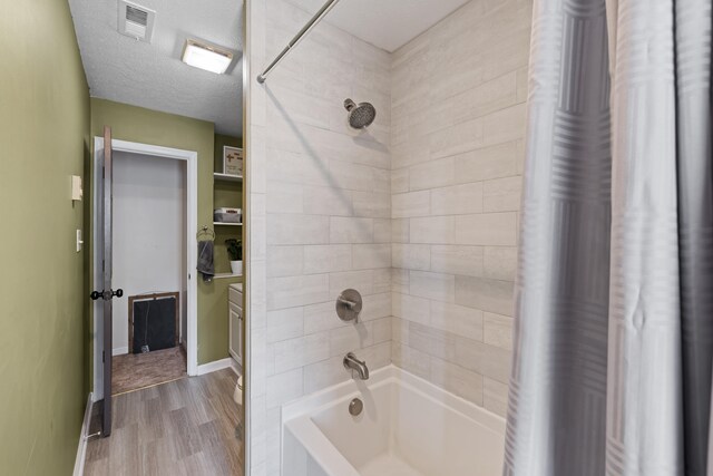 full bathroom featuring wood finished floors, shower / bath combo with shower curtain, and baseboards