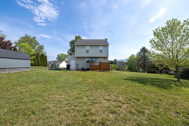 rear view of house featuring a lawn and a chimney