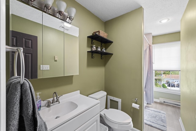 bathroom featuring a baseboard heating unit, toilet, a textured ceiling, baseboards, and vanity