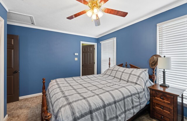 carpeted bedroom with attic access, ceiling fan, and baseboards