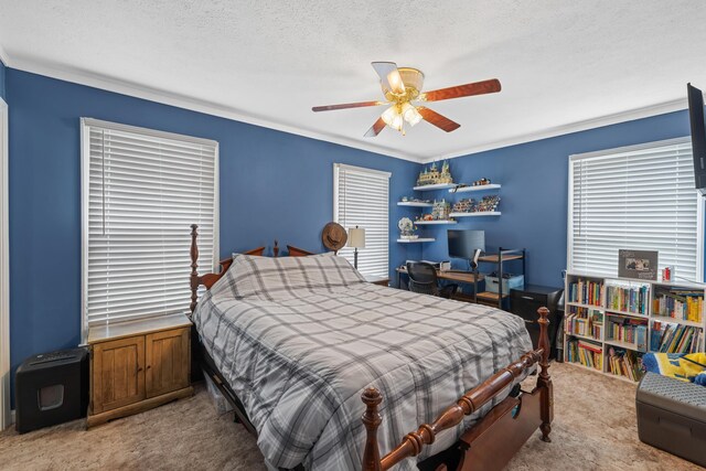 bedroom featuring carpet floors, a ceiling fan, ornamental molding, and a textured ceiling