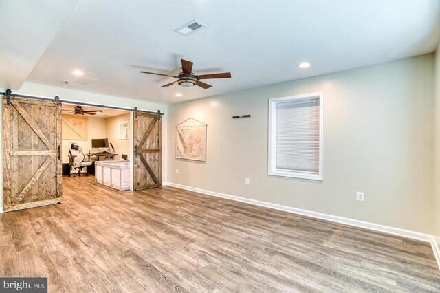 11400 Alvin Ln, Culpeper, VA 22701 - unfurnished living room with a barn door, wood finished floors, a ceiling fan, and recessed lighting