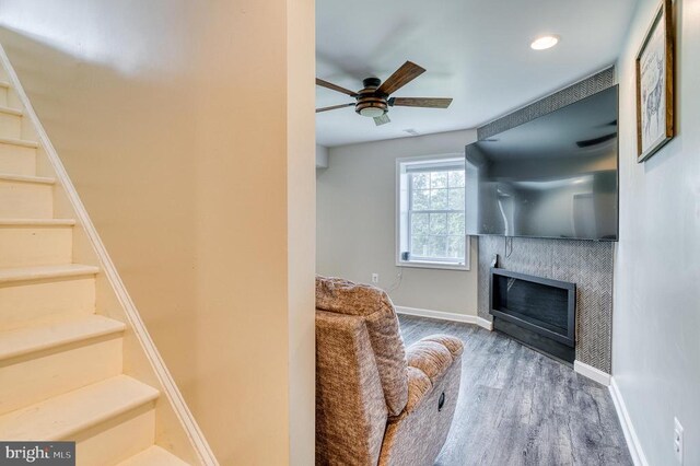 11400 Alvin Ln, Culpeper, VA 22701 - living room with wood finished floors, a glass covered fireplace, ceiling fan, stairway, and recessed lighting