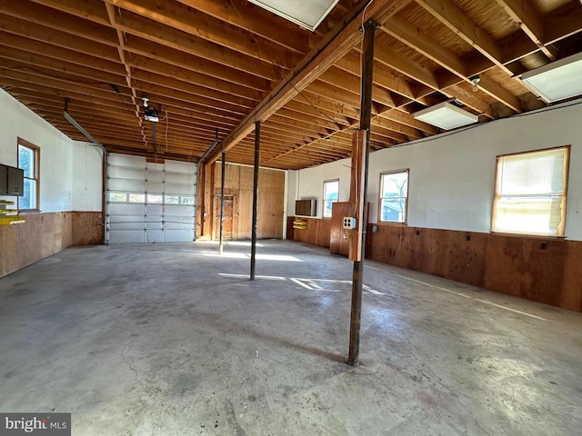 garage featuring wainscoting and wooden walls