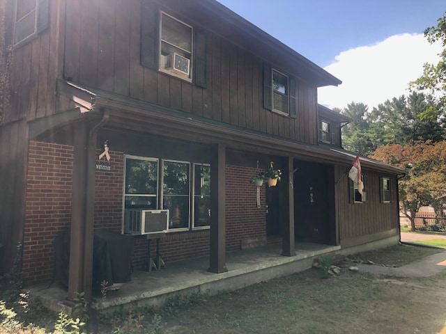 109 Cooper Dr, Stuarts Draft, VA 24477 - rear view of house featuring a porch, brick siding, and cooling unit