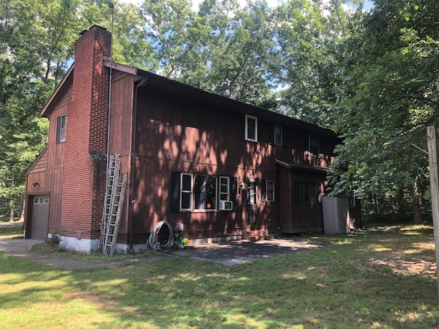 109 Cooper Dr, Stuarts Draft, VA 24477 - rear view of house featuring a chimney, a lawn, and a garage