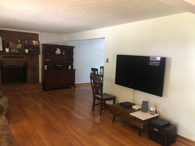 109 Cooper Dr, Stuarts Draft, VA 24477 - living area featuring wood finished floors, a fireplace, and a textured ceiling