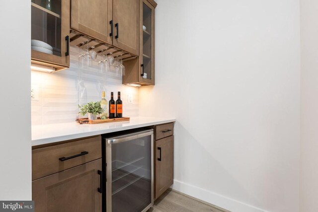 10103 N Streamview Ct, Fredericksburg, VA 22408 - indoor dry bar with beverage cooler, baseboards, backsplash, and light wood-type flooring