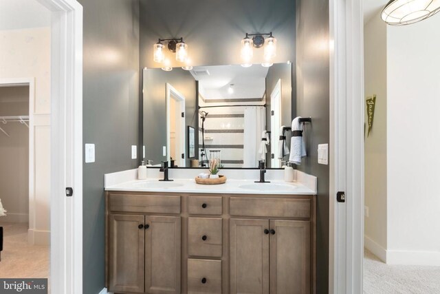10103 N Streamview Ct, Fredericksburg, VA 22408 - bathroom featuring a stall shower, double vanity, baseboards, and a spacious closet