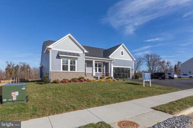10103 N Streamview Ct, Fredericksburg, VA 22408 - craftsman-style house with stone siding, a front yard, a garage, and asphalt driveway