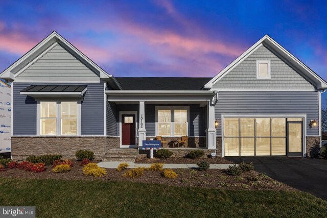 10103 N Streamview Ct, Fredericksburg, VA 22408 - view of front of home with a porch, stone siding, asphalt driveway, and a front yard