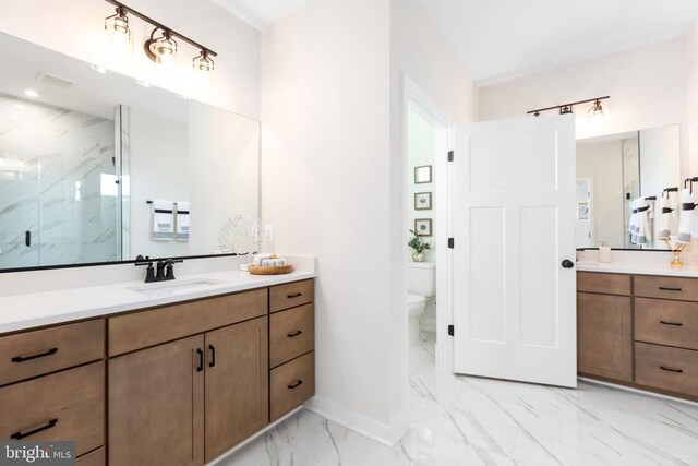 10103 N Streamview Ct, Fredericksburg, VA 22408 - bathroom featuring marble look tile flooring, a marble finish shower, toilet, vanity, and baseboards