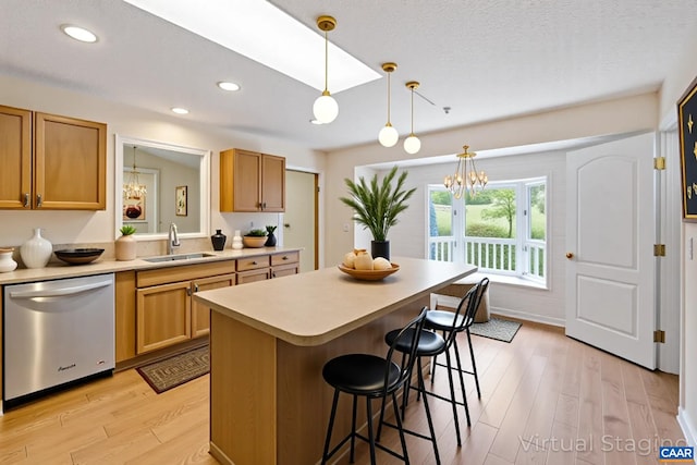 7 Spoon Ter, Palmyra, VA 22963 - kitchen featuring dishwasher, a chandelier, light countertops, light wood finished floors, and a kitchen breakfast bar