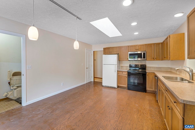 7 Spoon Ter, Palmyra, VA 22963 - kitchen featuring stainless steel appliances, a skylight, a textured ceiling, light countertops, and light wood-style floors
