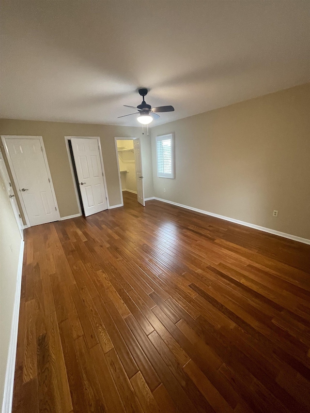 27 Shannon Pl Unit 27, Staunton, VA 24401 - unfurnished bedroom featuring dark wood-style flooring, a ceiling fan, and a walk in closet