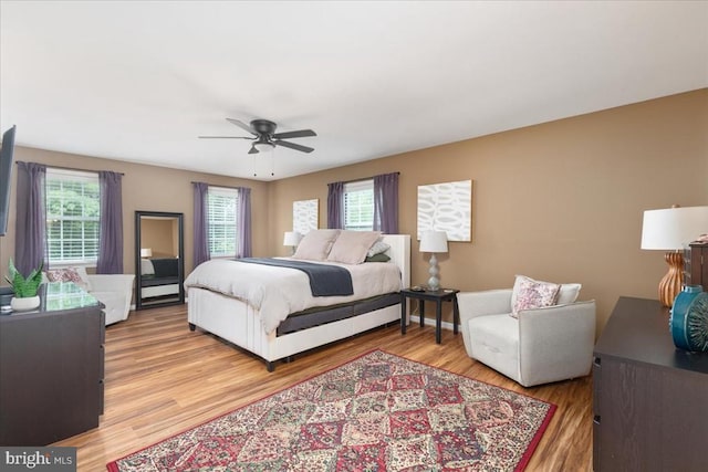  - bedroom featuring light wood finished floors and a ceiling fan
