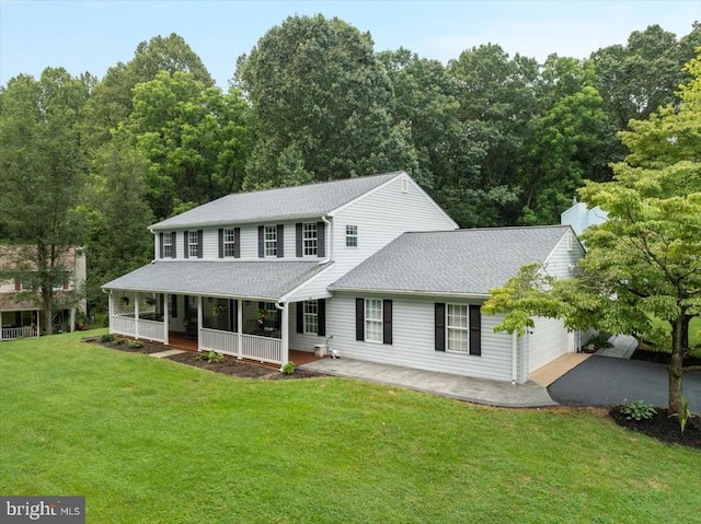  - view of front of property featuring covered porch, a garage, a front lawn, driveway, and a shingled roof