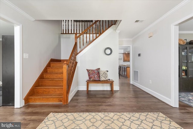  - stairway with wood finished floors and ornamental molding