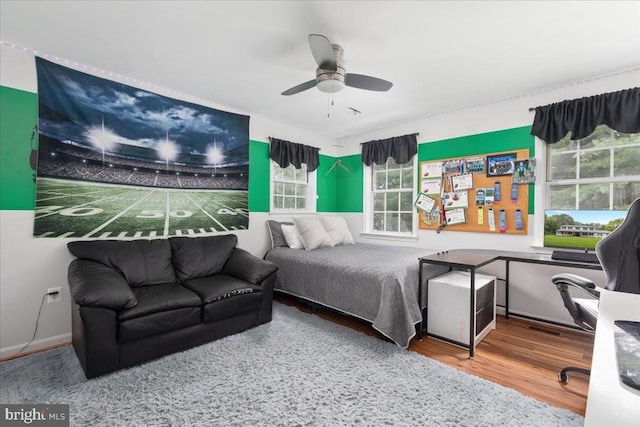  - bedroom with wood finished floors and ceiling fan
