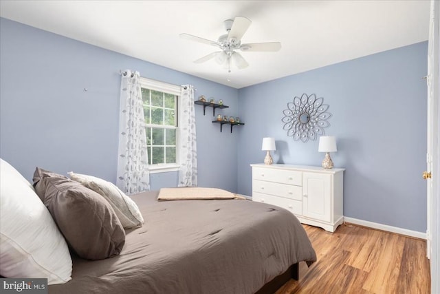  - bedroom with light wood-type flooring and a ceiling fan
