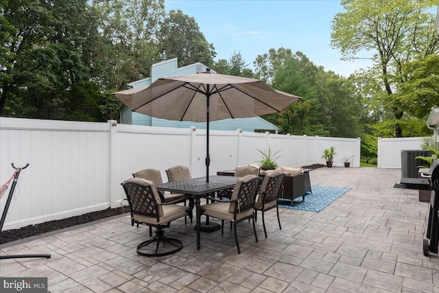  - fenced backyard featuring outdoor dining area, a patio, and view of wooded area
