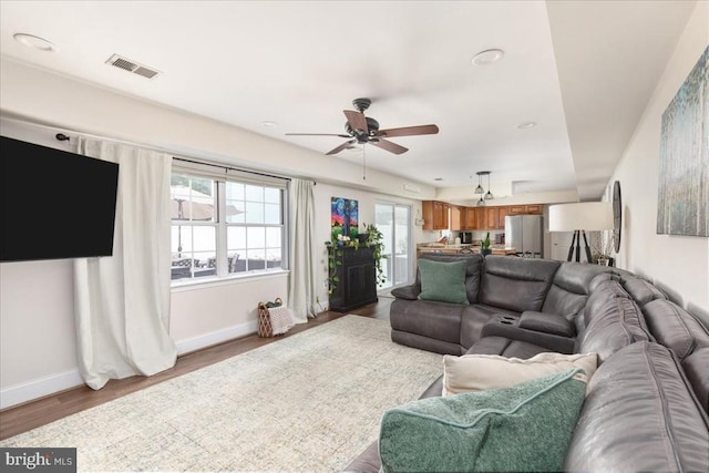  - living room featuring ceiling fan, wood finished floors, and recessed lighting
