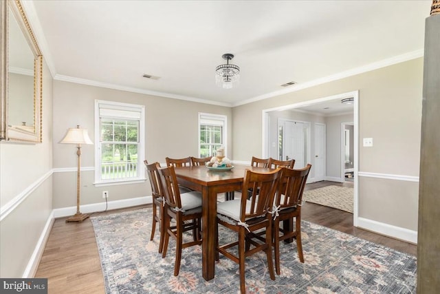  - dining room featuring wood finished floors and ornamental molding