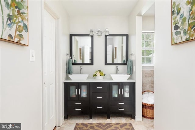  - full bathroom with double vanity and baseboards