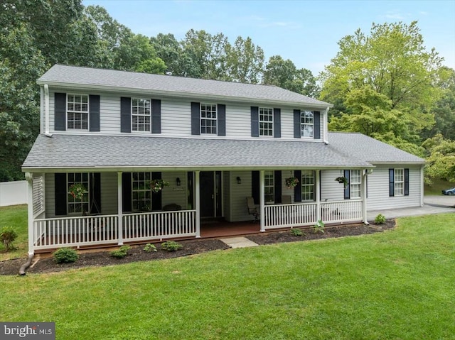  - view of front of house with covered porch, a front lawn, and a shingled roof