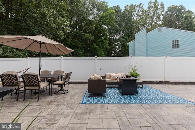  - fenced backyard with a patio, outdoor dining space, and an outdoor living space with a fire pit