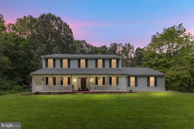  - view of front of house featuring covered porch and a front lawn