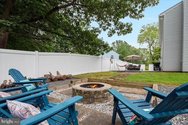  - view of patio featuring an outdoor fire pit