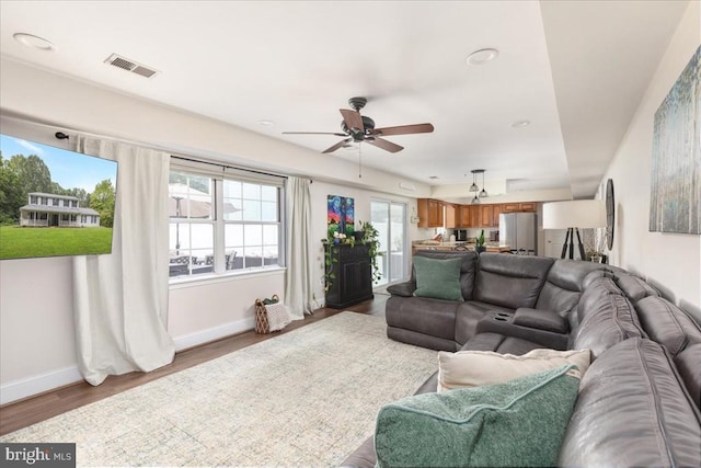  - living area featuring ceiling fan, wood finished floors, and recessed lighting